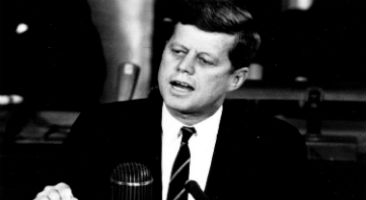 John F Kennedy speaking at a podium