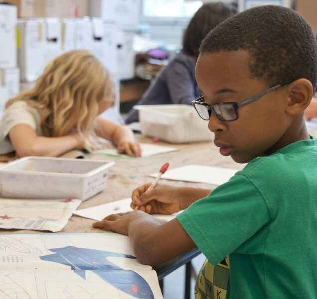 Young children doing homework at a table.