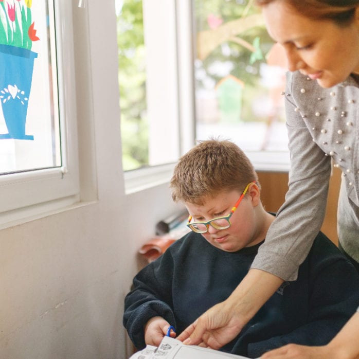 Special education teacher in the classroom with a student
