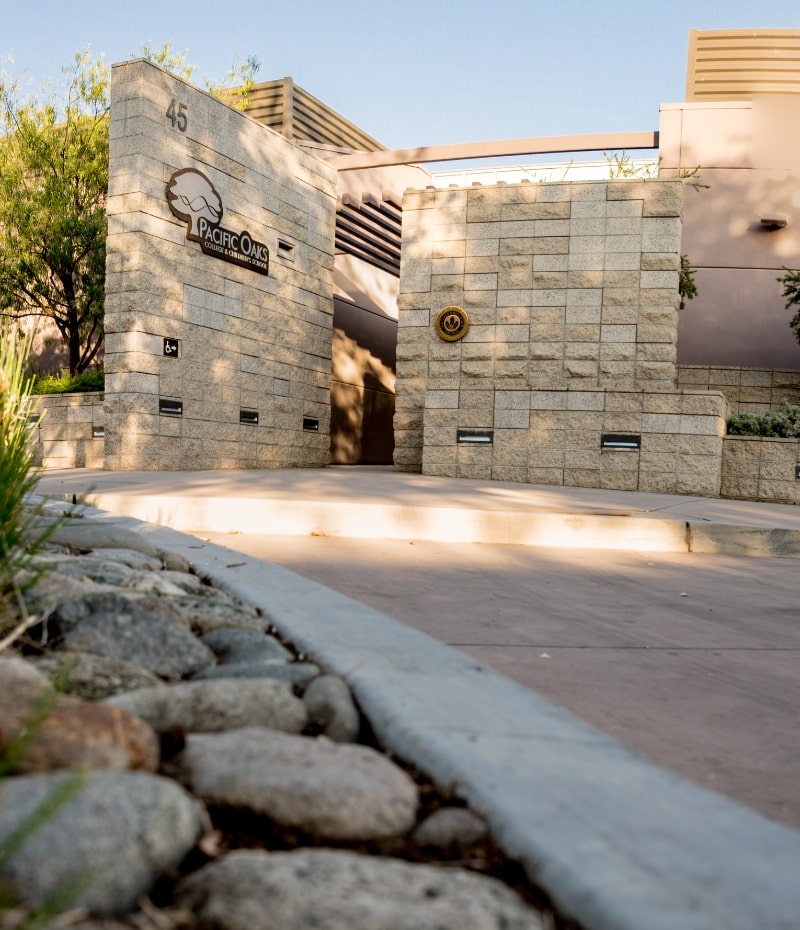 Pacific Oaks College and Children's School logo on stone wall from the ground u p